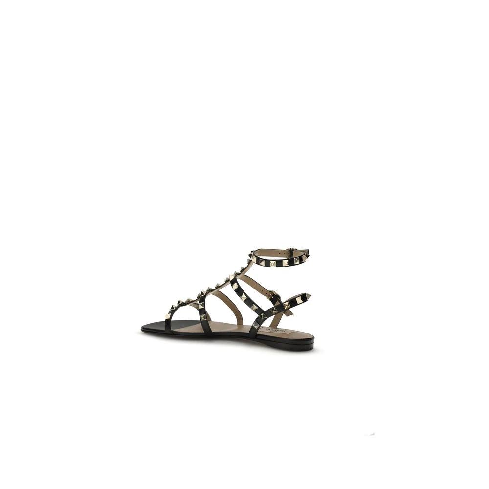 Valentino Garavani Schwarze Bos Taurus Kalbsleder Sandalen mit flacher Sohle by Valentino Garavani