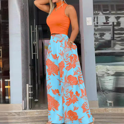 Zwei-teilige Damen-Setkombination mit WesteundHosePrintdesign Alltagsorientiert Vielseitig, orange Tops mit blauen Blumenhose.